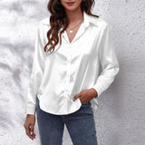 Emerald green satin long sleeve button-down blouse featuring a classic collar and button detailing, suitable for formal or casual wear.