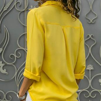 Emerald green silk blouse with long sleeves, featuring a satin finish, perfect for luxury spring fashion.