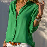 Emerald green silk blouse with long sleeves, shown in size XXXL, featuring luxurious satin fabric suitable for spring fashion.