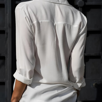 Emerald green long sleeve silk blouse with a satin finish, featuring a classic collar and button-down front, perfect for luxury spring fashion.