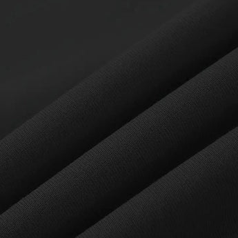 A classic black crewneck sweater for men, designed with a soft knit fabric, displayed in a casual setting against a simple background.