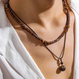 Ethnic Tribal Wooden Bead Necklace on a person's neck, showcasing its adjustable bohemian style and natural materials.