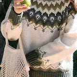 Cozy women's Nordic knit sweater in green, featuring a crew neck design with intricate Fair Isle patterns. The sweater is styled with long sleeves and a comfortable fit, ideal for 2XL size, perfect for winter fashion.