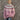 
A close-up image of a woman wearing a Fair Isle Women's Crew Neck Nordic Knit Sweater in seam pink, size 2XL. The sweater features a cozy woolen texture with a traditional Nordic pattern in pink and grey hues. The garment has long sleeves and a classic crew neck, showcasing a stylish and warm design ideal for winter fashion.