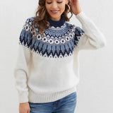 White Fair Isle wool sweater in size 2XL, featuring a Nordic winter pullover design. The model is smiling and the sweater has long sleeves, showcasing its handmade, ethical fashion craftsmanship.