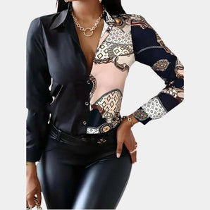 Fashionable women's asymmetrical print blouse in black and pink, featuring chic contrast sleeves, visible shoulder design, and a stylish neckline in size 2XL.