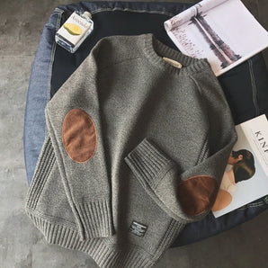 
A gray women's sweater with suede elbow patches, featuring a cozy knit design, displayed in a 4XL size. The sweater has a classic collar and long sleeves, showcasing a stylish outerwear option for colder weather.