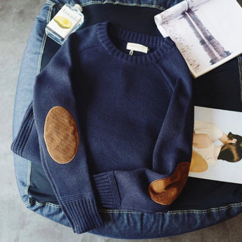 Fashionable women's blue sweater with suede elbow patches, featuring long sleeves and a cozy knit texture in a size 4XL.