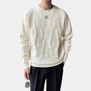 Men's designer sweater with a luxury embossed knit pattern resembling crocodile skin, featuring long sleeves and a classic collar, styled as outerwear.
