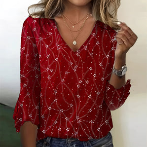Red V-neck sequin blouse with long sleeves, suitable for holiday parties, paired with jeans.