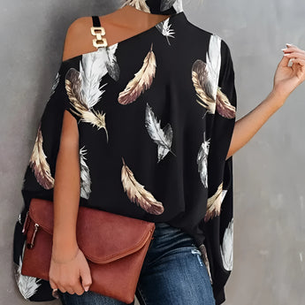 
A stylish black and white floral asymmetric one-shoulder blouse, designed as evening wear, showcasing a unique cut with one sleeve and an elegant pattern. The blouse is tailored to accentuate the waist and is suitable for formal occasions.