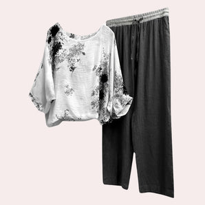 Floral batwing blouse and elastic waist trousers set in black, featuring an oversized blouse with wide batwing sleeves and matching trousers, designed for a comfortable yet stylish summer look in an XL size.