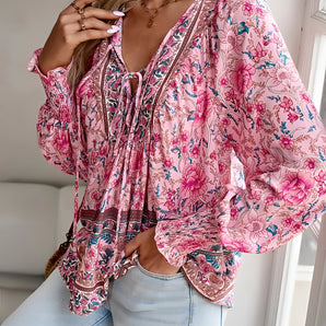 Floral Boho Blouse in Pink Paisley with Tassel Neck and Long Sleeves, showcasing a relaxed fit with intricate patterns and purple accents.