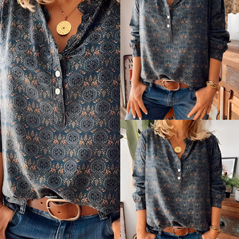 Floral Boho Chic women's blouse featuring long sleeves and a mandarin collar, paired with jeans. The blouse is white with intricate floral patterns, highlighting a fashionable and elegant design.