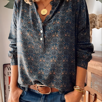 
A 3XL Floral Boho Chic Women's Blouse featuring long sleeves, a mandarin collar, and intricate textile design, showcasing a fashion-forward, relaxed style.
