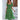 Woman wearing a green floral boho maxi dress with puff sleeves and a high slit, styled with her hair down, showcasing the dress's fashion-forward design and flattering fit in size XL.
