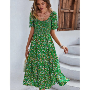 Woman wearing a green floral boho maxi dress with puff sleeves and a high slit, styled with her hair down, showcasing the dress's fashion-forward design and flattering fit in size XL.