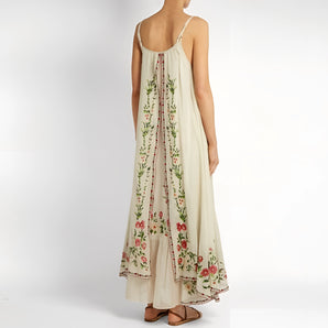 Floral embroidered bohemian maxi dress, sleeveless, featuring intricate floral patterns, ideal for beach and festival wear.