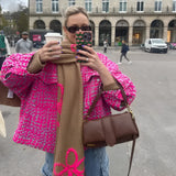 Floral Embroidery Pink Tweed Jacket worn by a woman with styled hair, wearing sunglasses and standing with her hand visible, showcasing the jacket's chic design and luxurious texture.