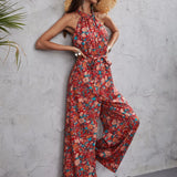 Floral halter neck jumpsuit featuring a tropical bohemian design, showcasing a one-piece garment with a focus on the shoulder and neck area, suitable for women's beachwear.