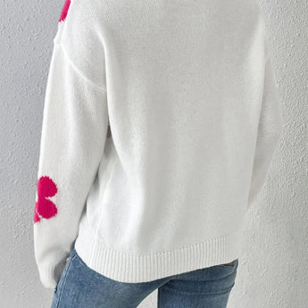 Floral knit sweater featuring a cozy design with long sleeves, a rounded neck, and a stylish collar. The sweater displays a vibrant floral pattern on a grey background, perfect for women's autumn and winter fashion.