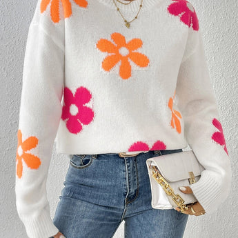 A vibrant floral knit sweater designed for women's autumn and winter fashion, featuring a cozy fit. The sweater has a textured textile pattern, long sleeves, and a comfortable collar. It is paired with jeans, showcasing a stylish and fashionable casual look.