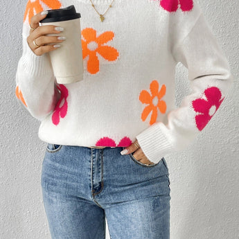 Vibrant floral knit sweater for women, featuring a cozy autumn/winter design with colorful patterns, long sleeves, and a comfortable neckline.