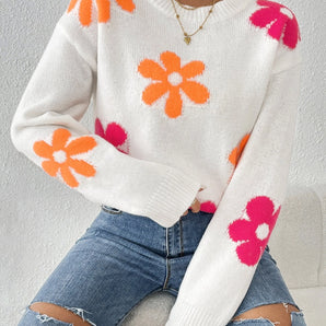 Vibrant cozy women's floral knit sweater with long sleeves and a round neck, showcased against a white background.
