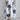 White floral maxi dress in an oversized print, featuring a unique contemporary design, suitable for plus size 5XL. The dress has sleeves and a neckline, and is designed for daytime wear.