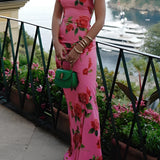 Pink floral mermaid dress with ruffled accents, perfect for garden parties, featuring intricate flower and plant designs, shown on a mannequin with a white background highlighting the dress's elegant neckline and sleeves.