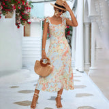 Pastel floral midi dress with short sleeves and a fitted waist, ideal for garden parties and vacations.