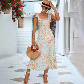Pastel floral midi dress with short sleeves and a fitted waist, ideal for garden parties and vacations.