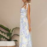 Floral midi dress in pastel colors with a garden party theme, featuring short sleeves, a fitted waist, and a flowing skirt that falls to the thighs; designed for vacation wear.