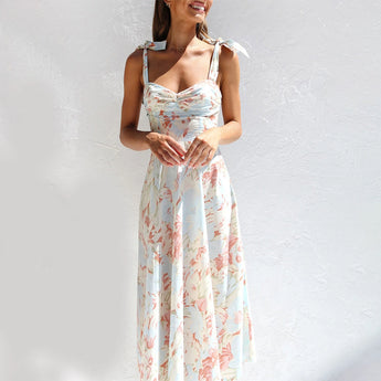 Floral midi dress with pastel garden party print, featuring short sleeves, a fitted waist, and a modest neckline, ideal for vacation or daytime events.