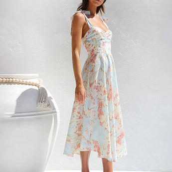 Apricot floral midi dress in a pastel garden party style, featuring a fitted waist, sleeveless design, and flowing skirt, suitable for vacation or casual wear, shown in size XL.