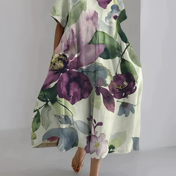 Floral oversized kaftan dress in watercolor design featuring purple floral patterns, with wide sleeves and a loose fit, suitable as lightweight beachwear. The dress is in white color and available in size 5XL.