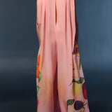 Elegant floral peach sleeveless jumpsuit for women, featuring a stylish neck design and fitted waist, ideal for summer fashion. Modeled to showcase its chic and versatile one-piece design suitable for both day and formal wear.