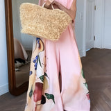 
A stylish floral peach sleeveless jumpsuit designed for elegant women's summer fashion, shown in a soft pink color in size 3XL. The jumpsuit features a flattering neckline and defined waist, making it a chic choice for warm weather.