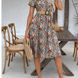Floral print A-line knee-length summer dress with short sleeves and a fitted waist, designed for a casual yet elegant look.