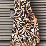 Floral print long sleeve button-front maxi dress with a defined waist and a chic, casual design.
