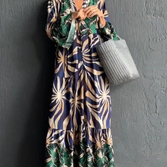 Floral Print Long Sleeve Button-Front Maxi Dress in Blu Tropicale color, highlighting the elegant green floral pattern, long sleeves, and button-front design. The dress features a fitted waist and flowing maxi length, perfect for a stylish and casual chic look.