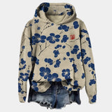 Women's oversized hoodie with a beige and black floral print, featuring a cowl neck.