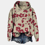 Oversized women's hoodie with a floral print in beige and black, featuring a cowl neck design and long sleeves.