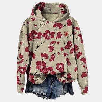 Oversized women's hoodie with a floral print in beige and black, featuring a cowl neck design and long sleeves.