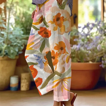 Woman wearing an orange floral print skirt with pastel botanical patterns, showcasing summer fashion in a lightweight textile, waist-high and suitable for size 2XL.