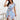 Sky blue floral print sleeveless summer dress, lightweight knee-length casual design, modeled by a smiling woman.