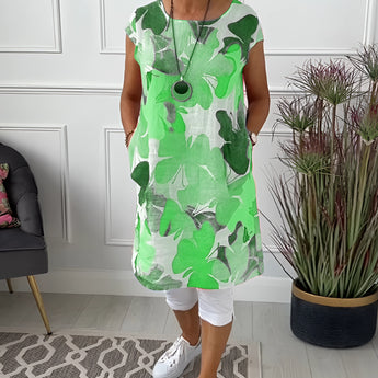 Sleeveless green tunic top with floral print for women, displayed on a mannequin, showcasing the dress's design and fit.