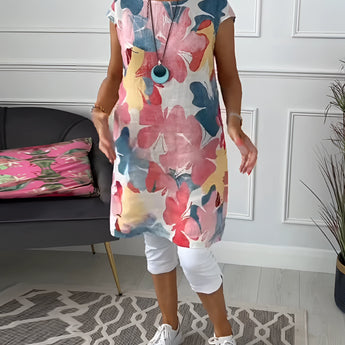 Floral print sleeveless summer tunic top for women displayed on a mannequin, showcasing its vibrant floral design, sleeveless cut, and relaxed fit.