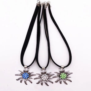 Floral statement necklace featuring crystal flower pendants in silver and white tones, designed as a bold fashion accessory.