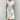 White botanical print floral summer dress for women, featuring short sleeves and a midi length. The dress is designed with a focus on shoulders and waist, suitable for daytime wear.